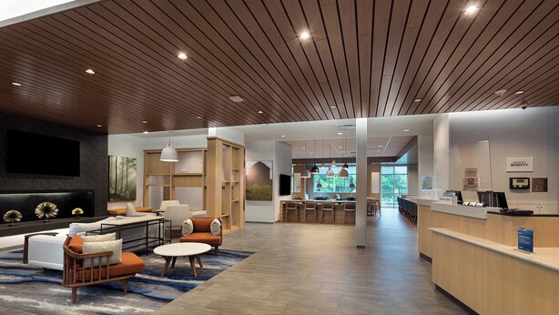 A spacious lobby with a modern design, featuring a seating area with sofas and chairs, a kitchen area, and a reception desk. - Fairfield Inn & Suites by Marriott Statesville (Statesville)