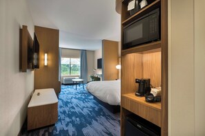 A hotel room with a bed, a desk, a microwave, a coffee maker, and a view of the outdoors. - Fairfield Inn & Suites by Marriott Statesville (Statesville)