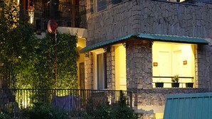 A stone building with a balcony, a door, and a window. - Araiya Palampur (Palampur)