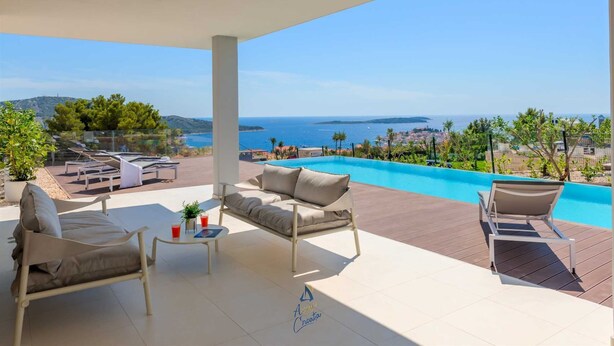 A spacious balcony with a view of the sea, a pool, and outdoor furniture. - Top luxury design villa for 8 with pool near sea (Primošten)