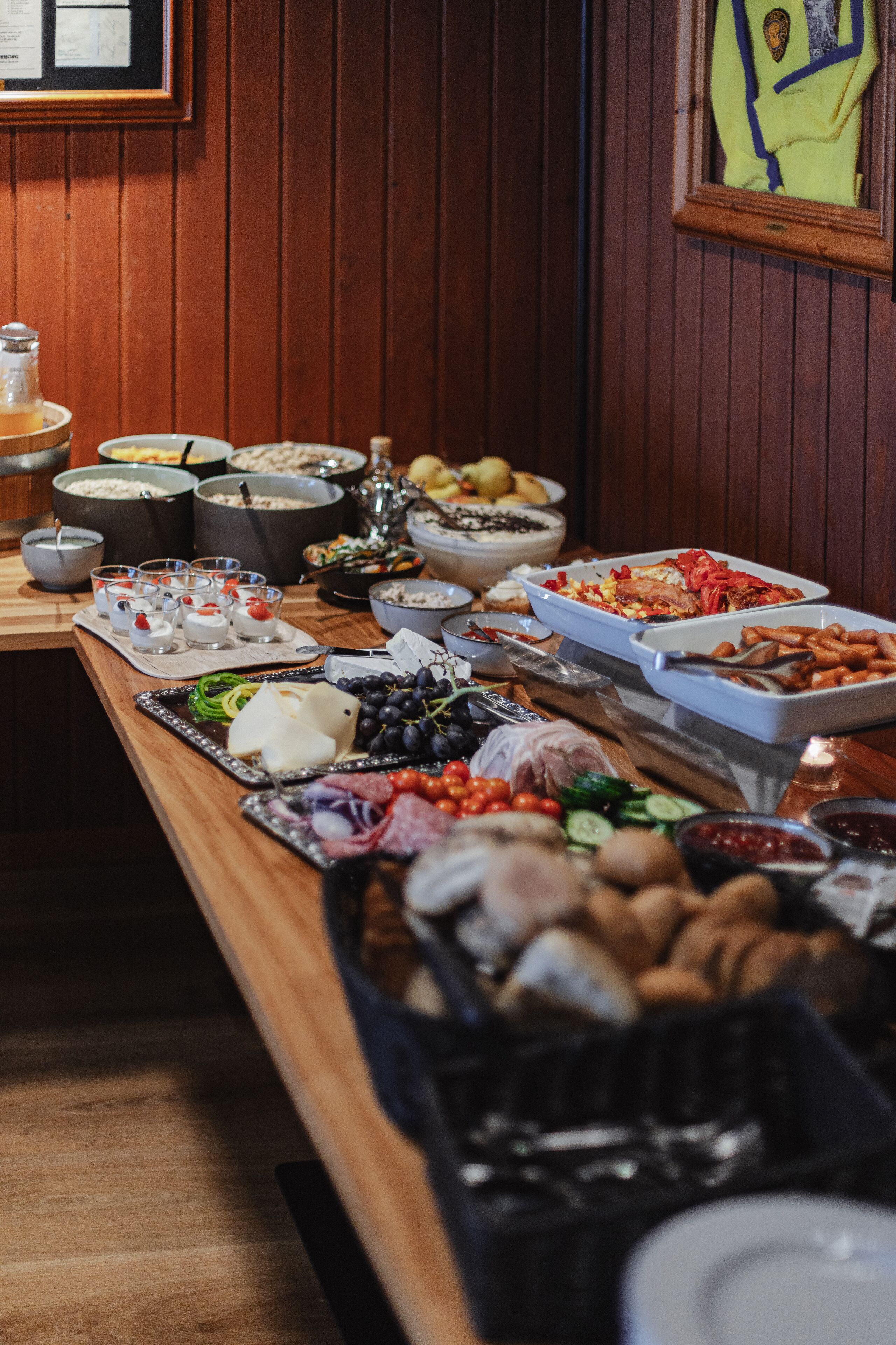 A buffet table with various food items and dishes.