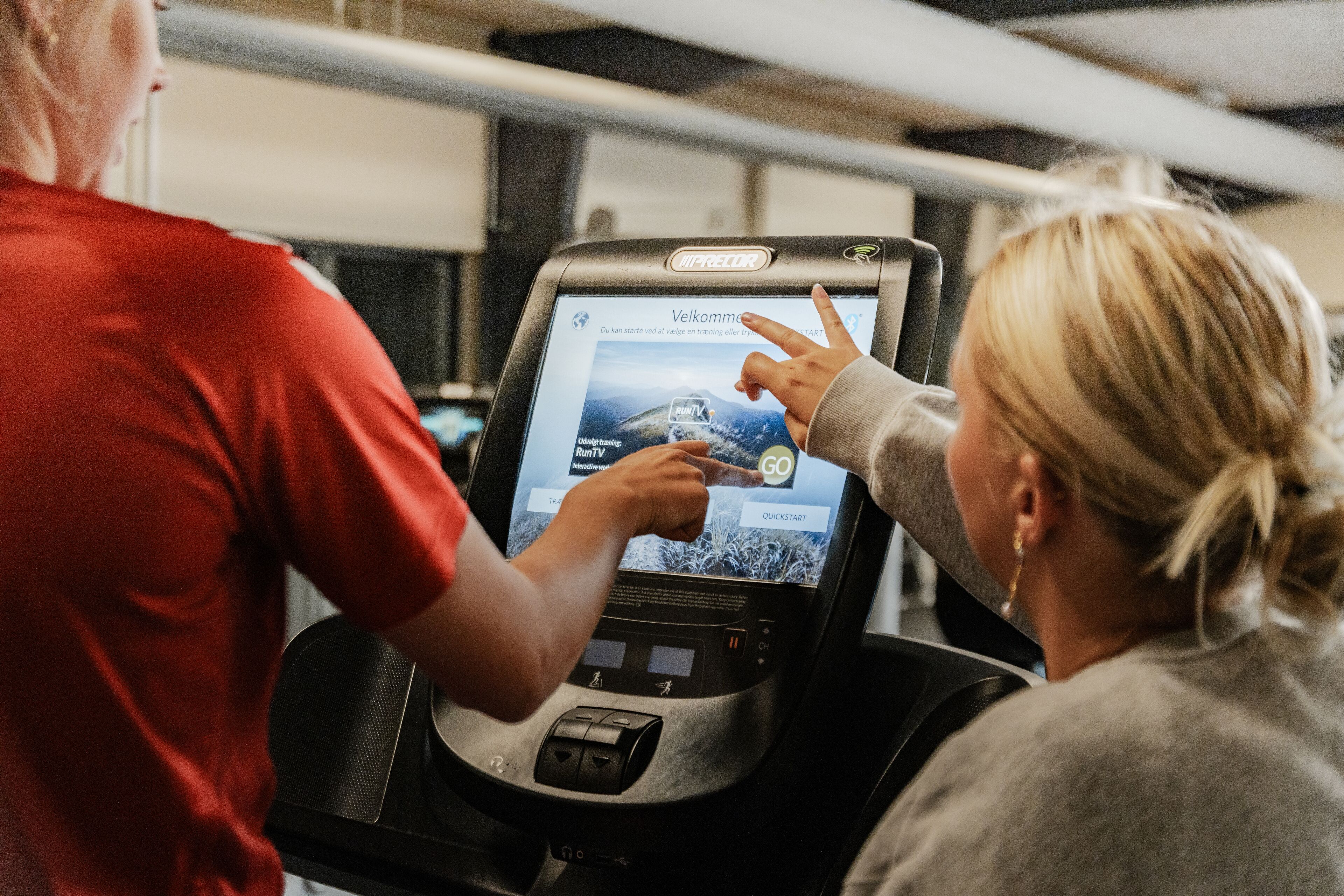 A treadmill with a digital display screen.
