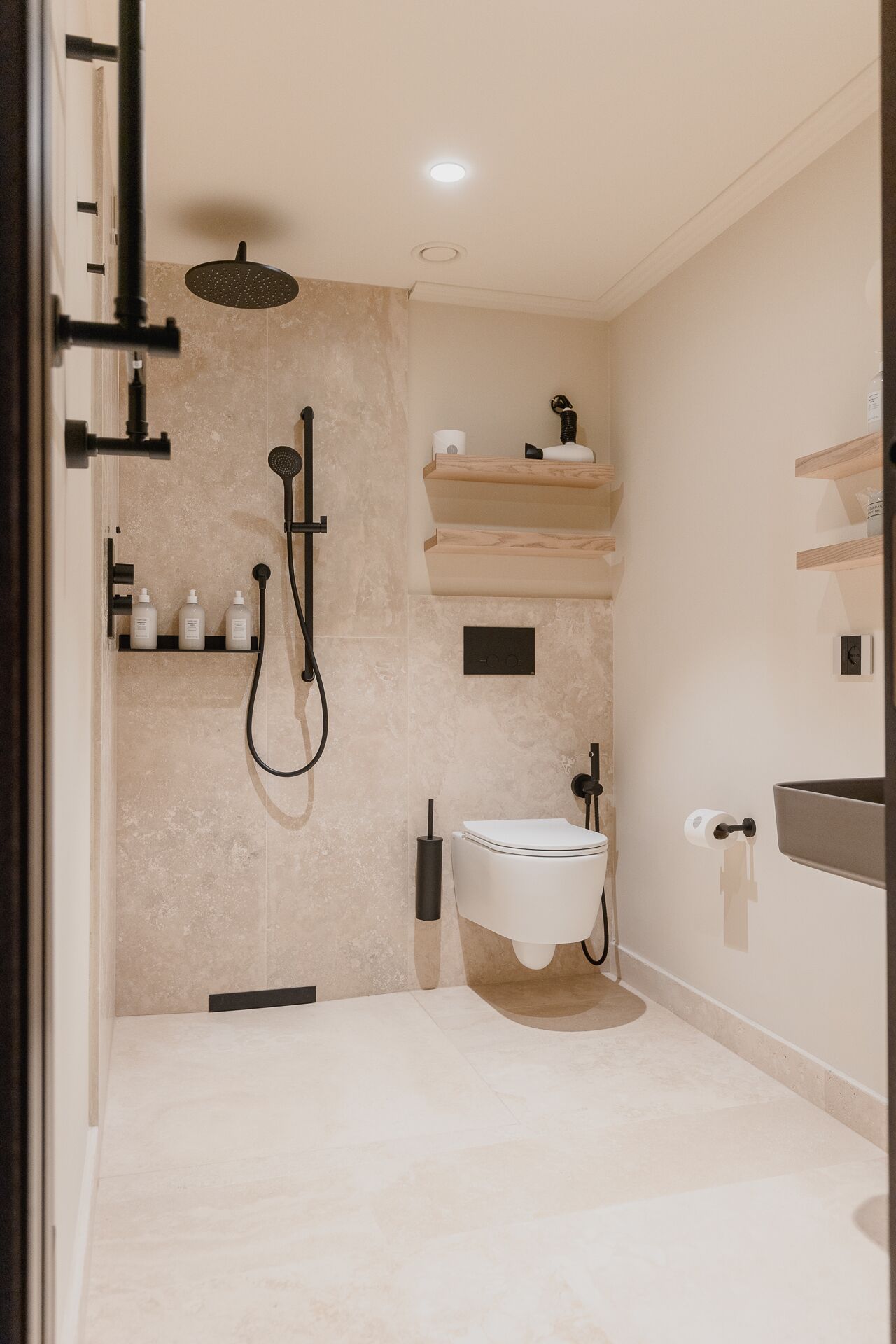 A modern bathroom with a shower, toilet, and vanity.