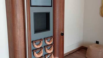 A wooden door with a vertical handle and a small window.
