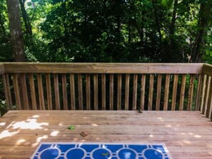 A wooden deck with a blue mat featuring circular patterns.