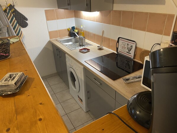 Enjoy cooking in this kitchen with a stainless steel sink, dishwasher, microwave, and induction cooktop.
