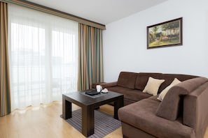 Relax in this stylish living room with a sofa, coffee table, and a beautiful painting above.