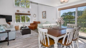 A spacious living room with a dining area, large windows, and a view of the outdoors. - One of kind 3 bedroom Villa with Ocean/Lagoon Views. (Hilton Head Island)
