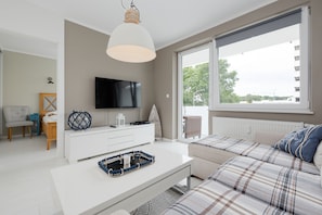 Apartment, 1 Bedroom, Balcony, Beachside | Living room | 40-inch TV with cable channels