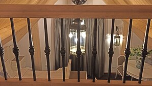 A wooden ceiling with a clock and a chandelier in a room with a table and chairs. - Chiristinahoeve De kasteel #7 (Boskoop)