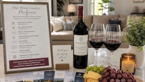 A framed sign listing wine country partners with a bottle of Hermosillo wine and glasses on a table. - Sonoma Wine Country Retreat | Near Top Wineries + Cozy Escape (Santa Rosa)