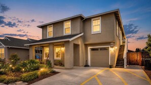 A two-story house with a garage, a covered porch, and a staircase leading to the garage. - Sonoma Wine Country Retreat | Near Top Wineries + Cozy Escape (Santa Rosa)