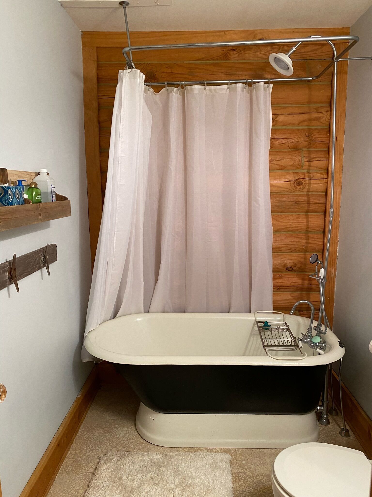 A bathroom with a freestanding bathtub, a shower, and a toilet.