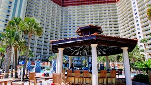 Un hotel con un patio central que cuenta con asientos al aire libre y un pabellón cubierto.