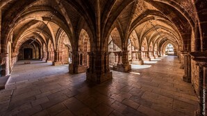 A cathedral interior with a series of arches and columns, a stone floor, and a long, narrow nave. - JOSEPHINE BEDROOM  (Luxeuil-les-Bains)