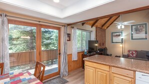 A kitchen with wooden cabinets, a granite countertop, and a built-in dishwasher. - Evergreen B5 (Brian Head)