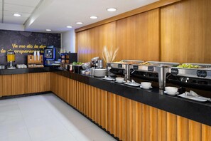 A buffet area with various food stations, including a coffee machine and a salad bar. - Hotel MX forum buenavista CDMX, Trademark by Wyndham (Mexico City)