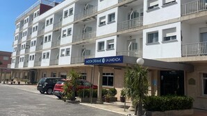 A multi-story hotel with balconies, a sign reading "MOON DREAMS LA LANZADA", and a paved parking area. - Bluesea Costa Norte (Sanxenxo)