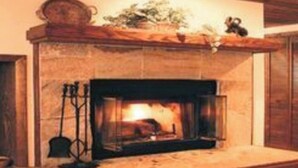 A fireplace with a mantel, a vase, and a small sculpture. - (1)Big Sky 2BR Condo w/outdoor heated pool/hot tub (Big Sky)