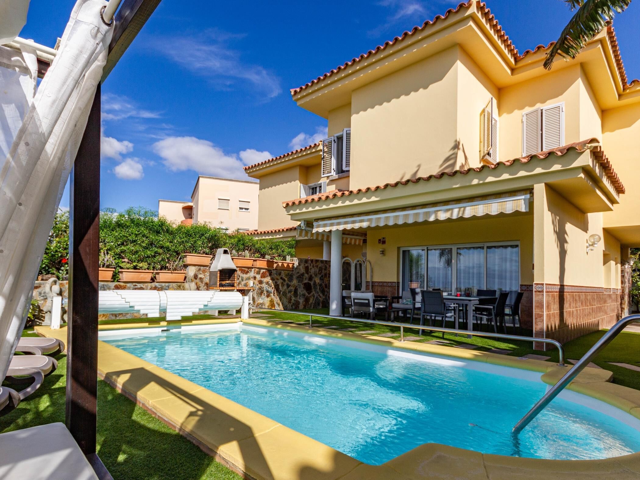A heated pool, sun loungers