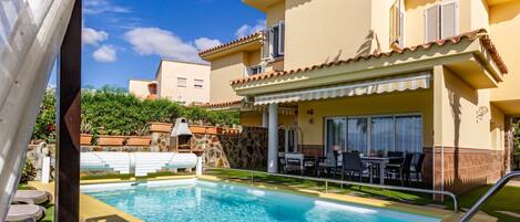 A heated pool, sun loungers
