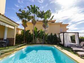 A heated pool, sun loungers