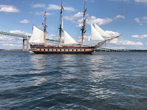 A large sailing ship with multiple masts and sails, docked near a bridge. - Beautiful Coastal Loft - 5 Minute Walk to Beach (Jamestown)