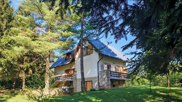 A two-story house with a stone facade, a balcony, and a sloped roof. - Anemona House - Plitvice Lakes - 500 m  from  Big Waterfall (Plitvice Lakes)