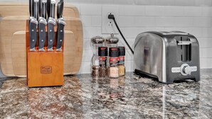 A kitchen counter with a knife block, a toaster, and salt and pepper shakers. - ★ Stunning 3BR Modern Charm in South Philly ★ (Philadelphia)