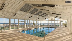 An indoor swimming pool with a view of the ocean, large windows, and a tiled floor. - Perdido Sun #802 - Little Piece of Paradise on the Beach! Large Balcony! (Pensacola)