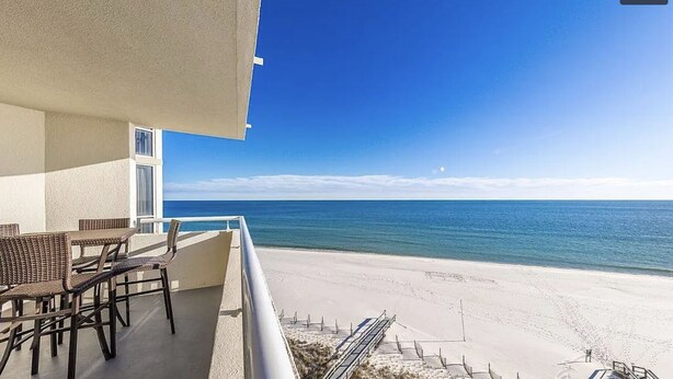 A balcony with wicker furniture overlooking a beach and ocean. - Perdido Sun #802 - Little Piece of Paradise on the Beach! Large Balcony! (Pensacola)