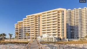 A multi-story hotel with a central courtyard and a beachside promenade. - Perdido Sun #802 - Little Piece of Paradise on the Beach! Large Balcony! (Pensacola)