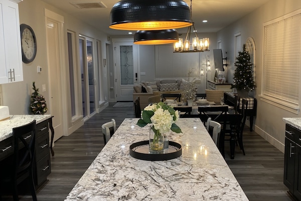 Massive island with built in cabinetry and wrap-around bar-stools.