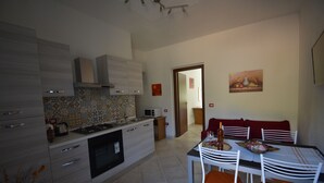 A modern kitchen with a dining area.