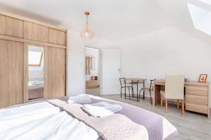Desk, laptop workspace, cots/infant beds, bed sheets