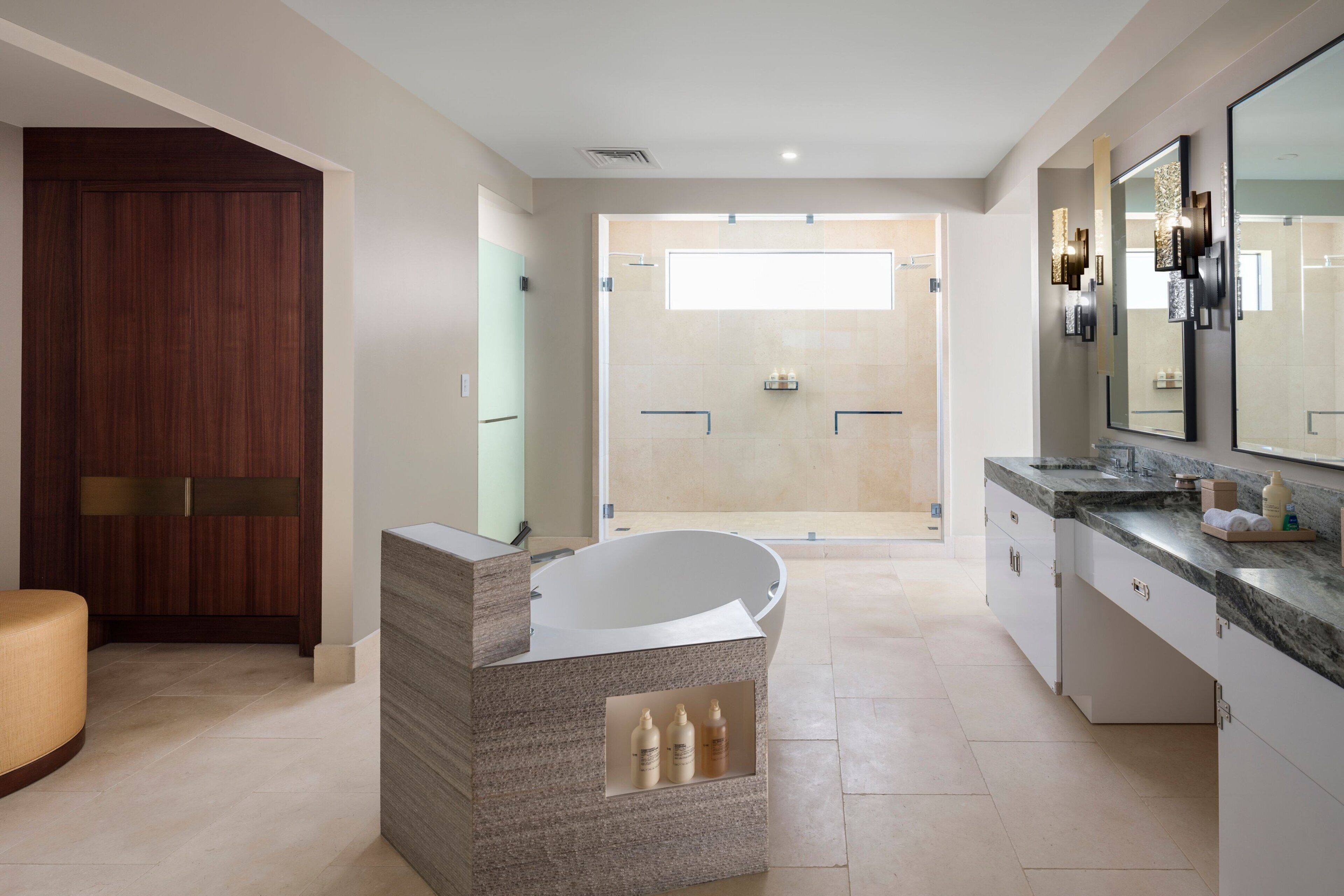 A modern bathroom with a freestanding bathtub, a large mirror, and a walk-in shower.