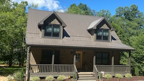 A two-story wooden cabin with a porch and a small front yard. - Sweets River Nest-riverfront/tube/hot tub/log cabin-fishing- Valle Crucis/App ST (Banner Elk)