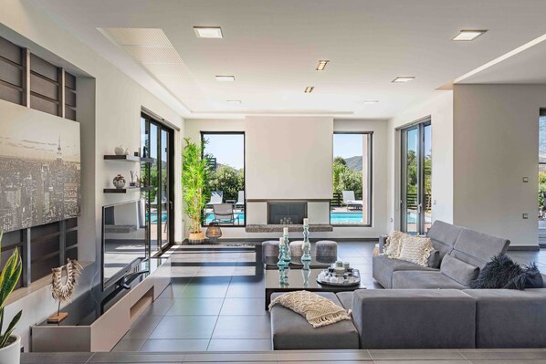 Luxury Villa, 6 Bedrooms, Private Pool, Mountain View | Living area | 32-inch flat-screen TV with satellite channels, TV, fireplace - Villa Vega (Platanias)