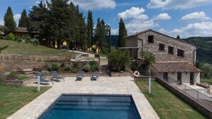 A stone building with a pool, lounge chairs, and a view of the surrounding landscape. - Gittori, Gaiole in Chianti, Siena and Chianti (Gaiole in Chianti)