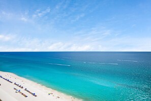 A beach with clear turquoise water and a sandy shore.