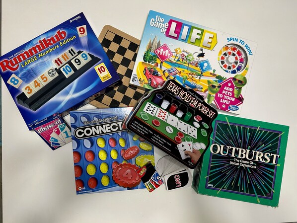 A variety of board games including Connect Four, Texas Hold 'em Poker Set, and Outburst.