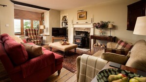 A cozy living room with a fireplace, a television, and comfortable seating. - HEATHERDENE - Cottage set in the midst of the Yorkshire Dales with amazing views (Richmond)