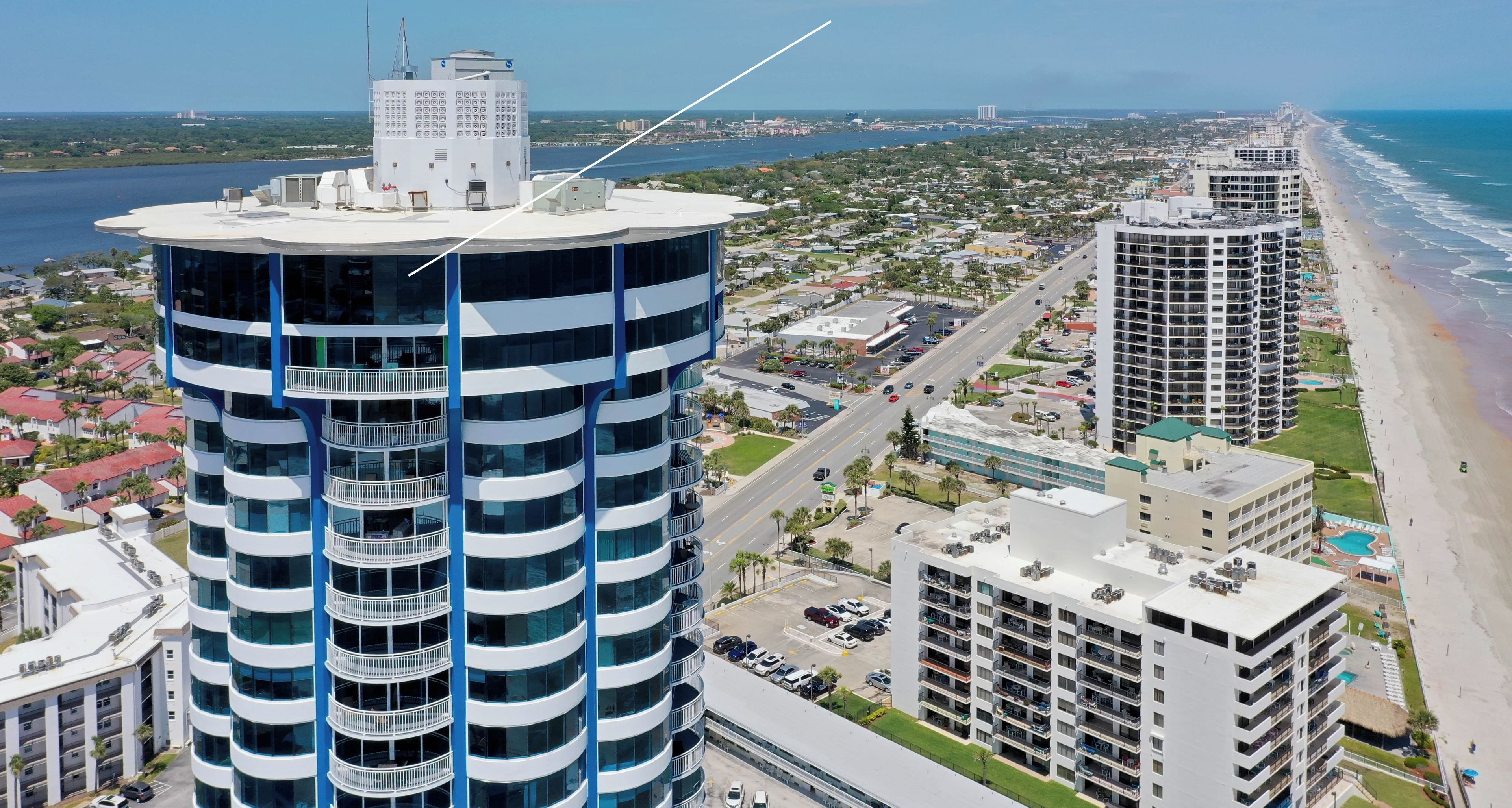 A high-rise building with a rooftop restaurant named Daytona Restaurant.