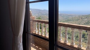 Ein Zimmer mit großem Fenster und Blick auf eine Berglandschaft.