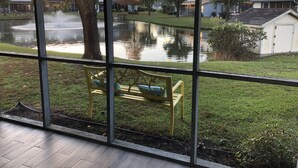 A view through a window of a bench and a pond in a residential area. - 💗☀️🌊Family Fun In The Sun🌊☀️💗 - 3 BR, 3.5 BA & Pet Friendly Townhouse (Little River)