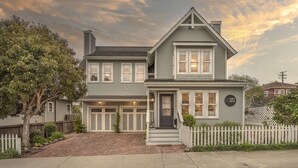 A two-story house with a front porch, a garage, and a picket fence. - 3813 Point Break ~ Walk to Lover's Point Beach! (Pacific Grove)