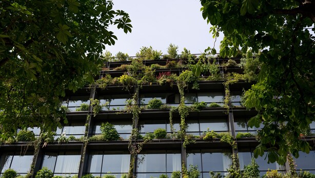A multi-story building with extensive vertical gardens covering the exterior. - Villa M (Paris)