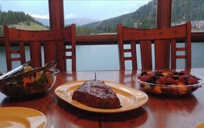 Enjoy meals with a view of the surrounding mountains from this dining table.