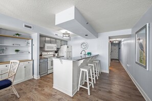 Enjoy cooking in this well-lit kitchen with a central island and microwave.