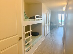 A corridor with bunk beds and a view of the beach. - Barefoot at Calypso III, handicap, 4/4 + bunks (Panama City Beach)